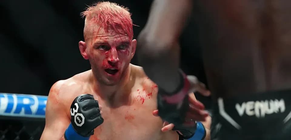 Bloodied fighter in defensive stance during match