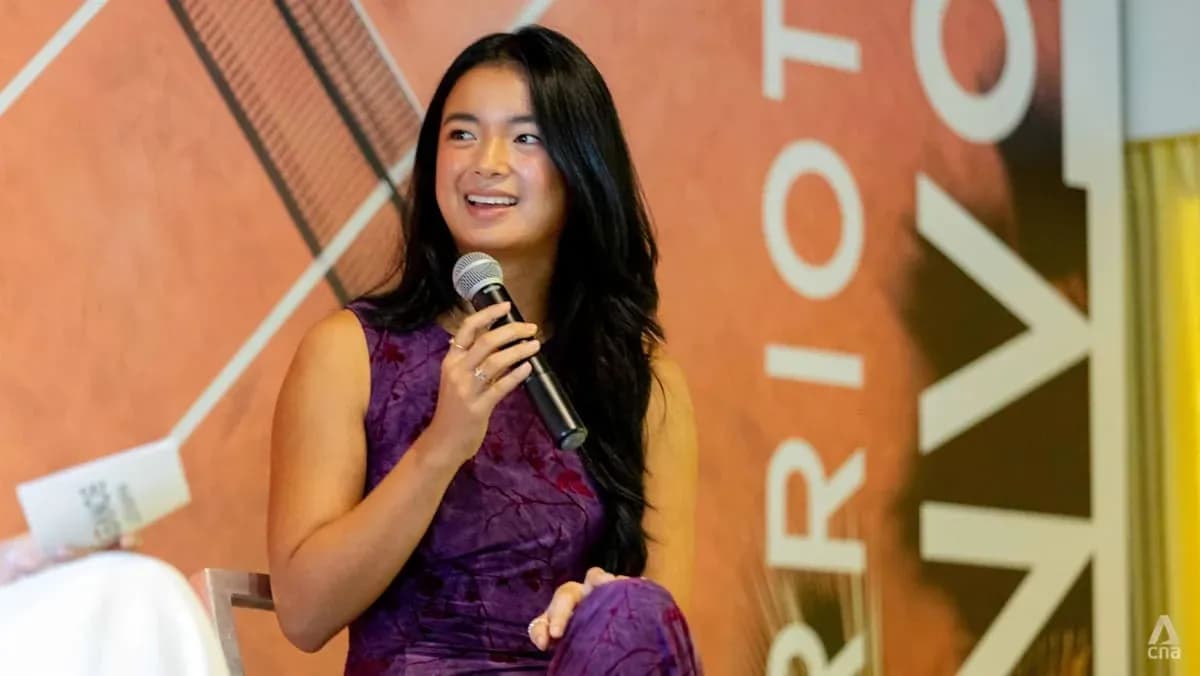 Young woman speaking into a microphone at event