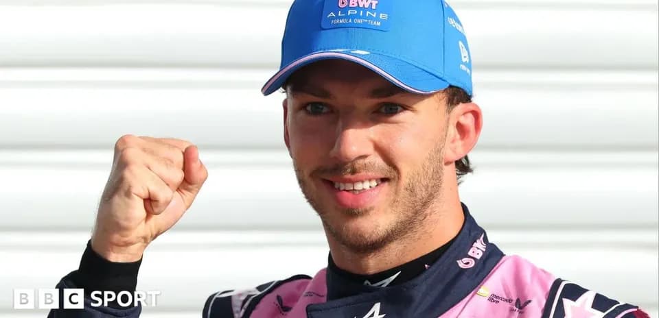 Driver celebrating with a raised fist in paddock