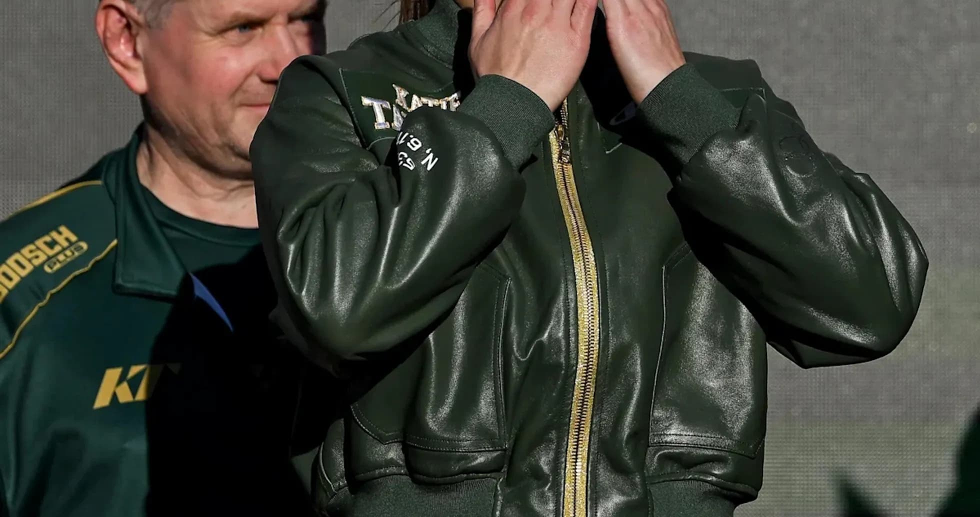 Female boxer blowing kisses at event stage
