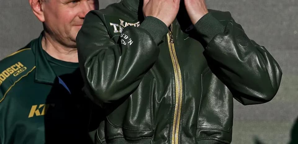 Female boxer blowing kisses at event stage