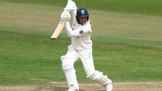 Batsman playing a shot on cricket field