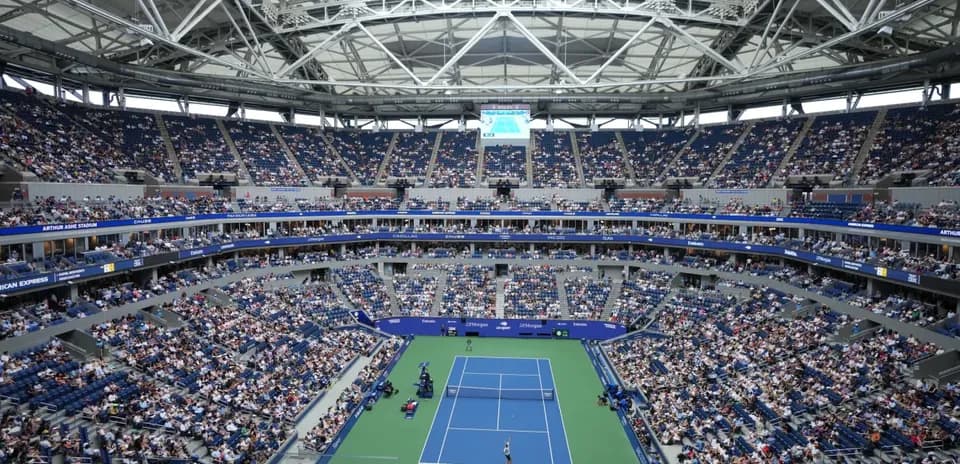 Crowd watching a tennis match at Arthur Ashe Stadium