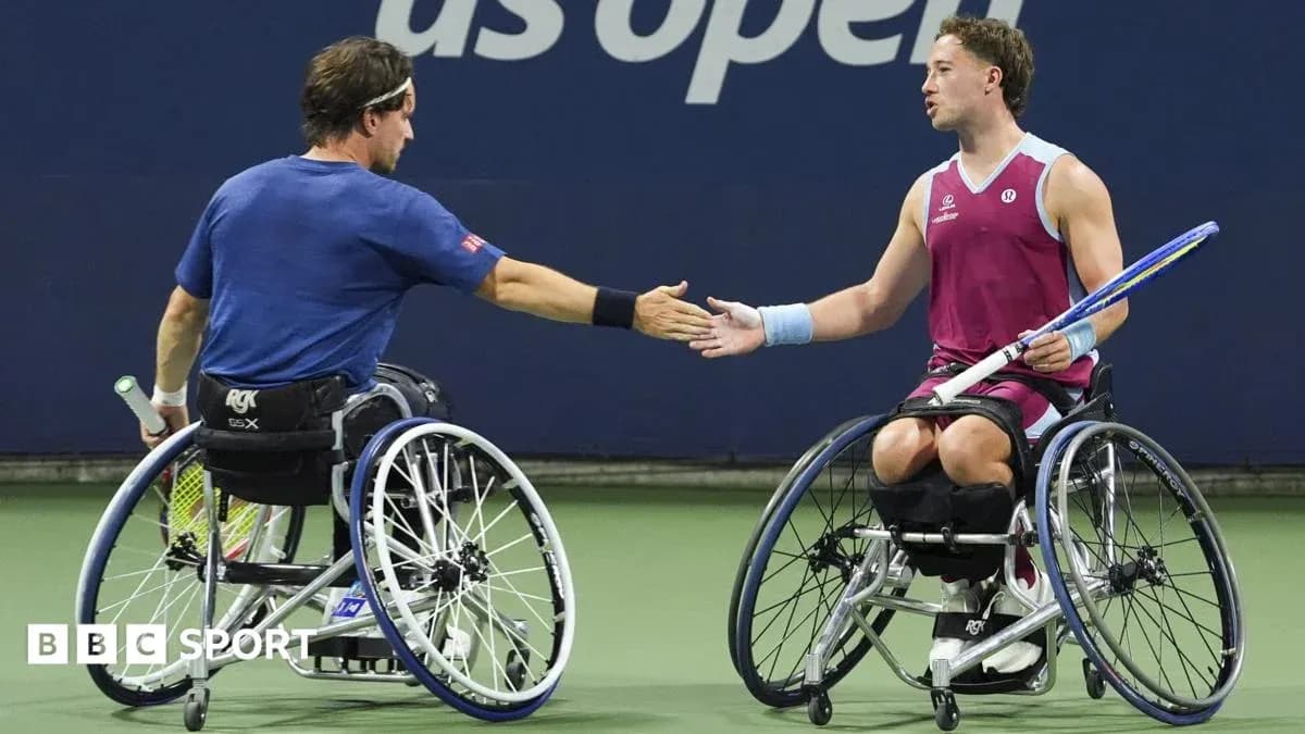 Two wheelchair tennis players shaking hands on court