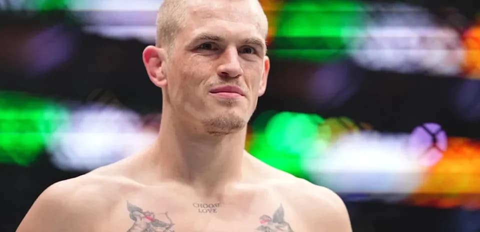 Bare-chested fighter with tattoos in arena