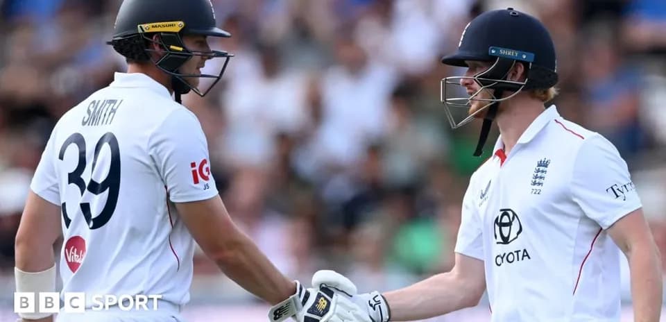Two cricketers shaking hands during a match