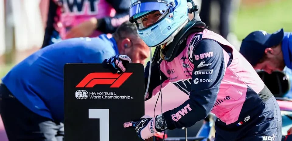 Driver holding number one sign during Formula 1 event