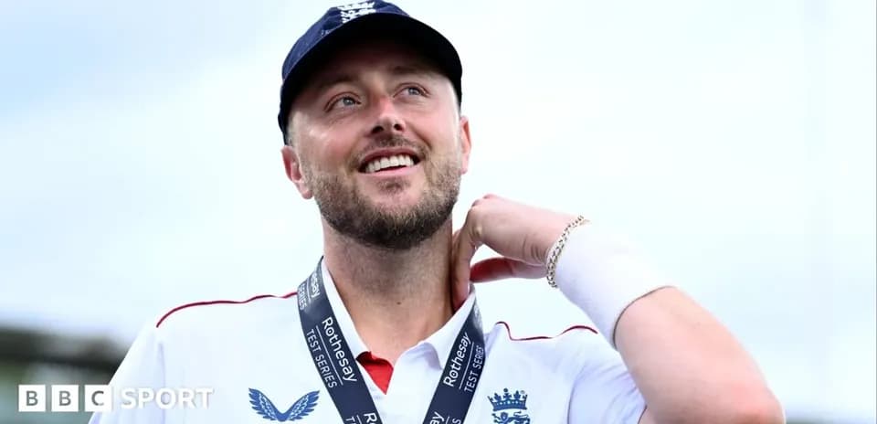 Cricketer wearing a medal and smiling after match