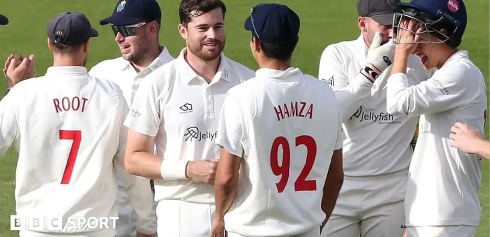 Cricket players celebrating a wicket on the field