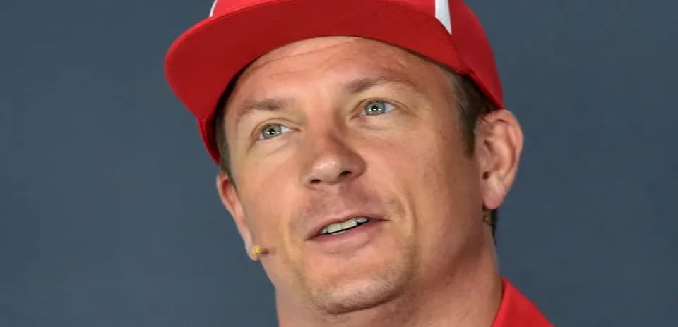 Driver wearing a red cap during press conference