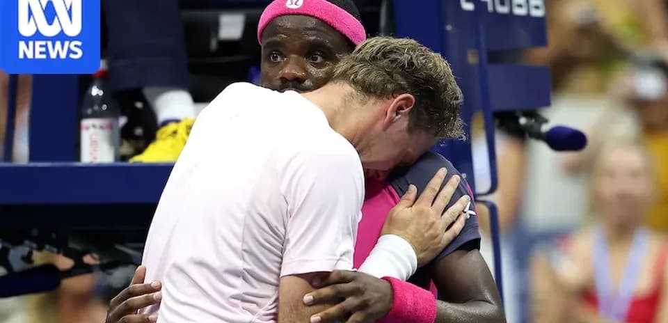 Two players embracing during a tennis match