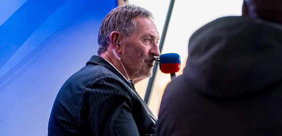 Sports commentator speaking into a microphone