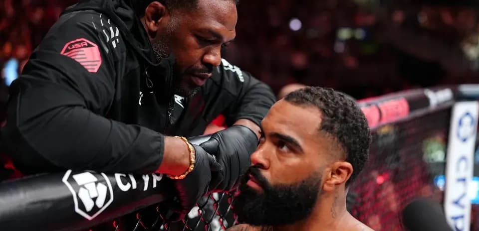 Coach advising fighter during MMA match corner