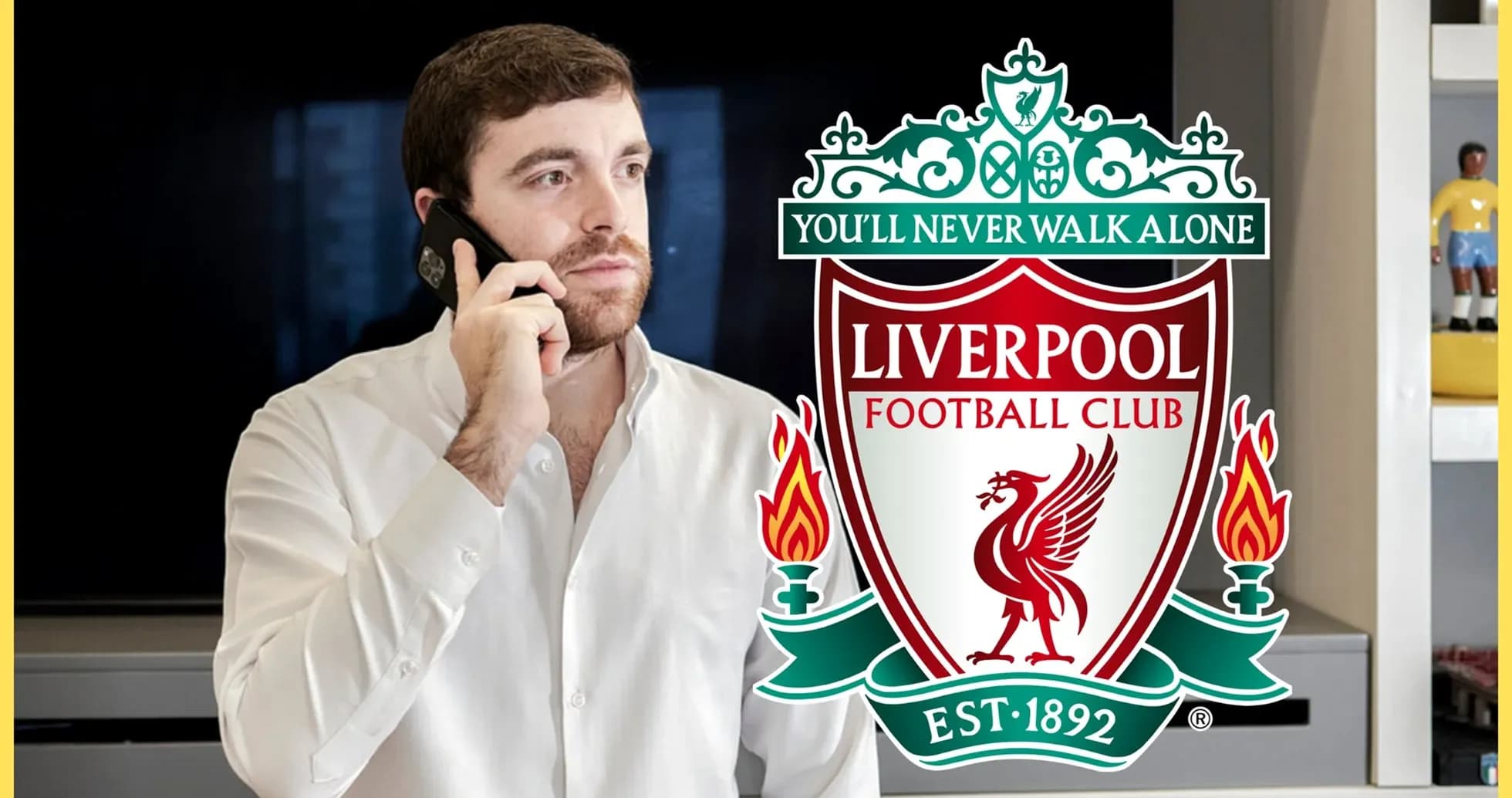 Person on phone with Liverpool FC logo in background