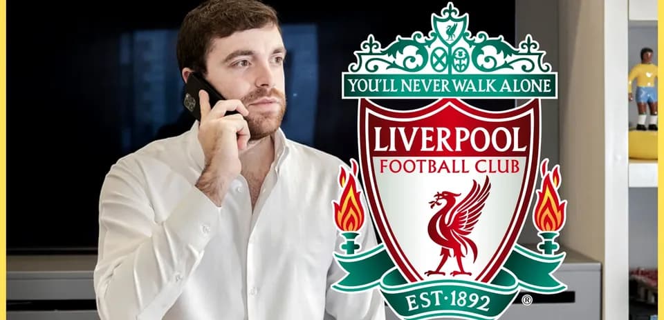 Person on phone with Liverpool FC logo in background