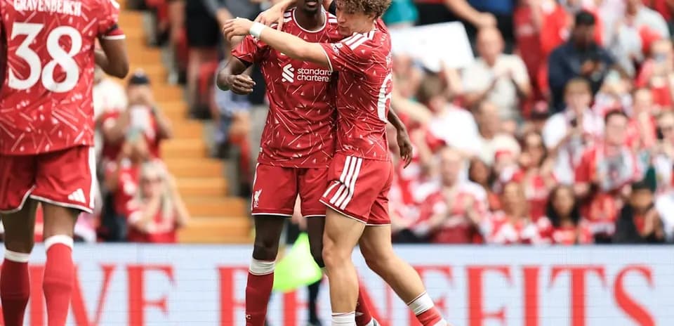 Two Liverpool players celebrating during a match