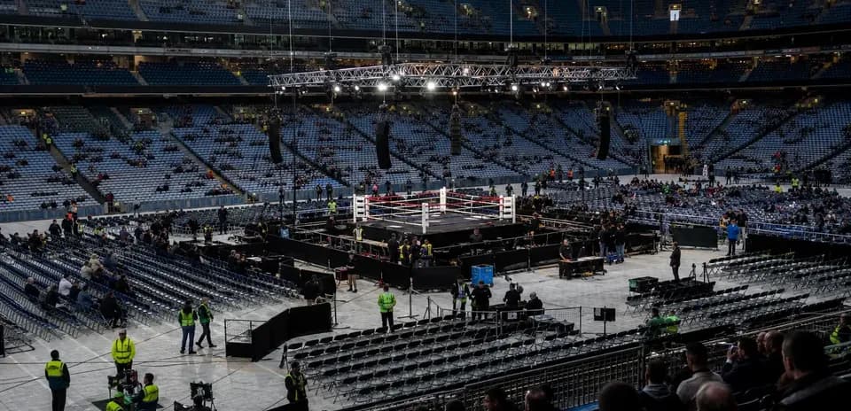 Boxing ring set up in a large empty stadium