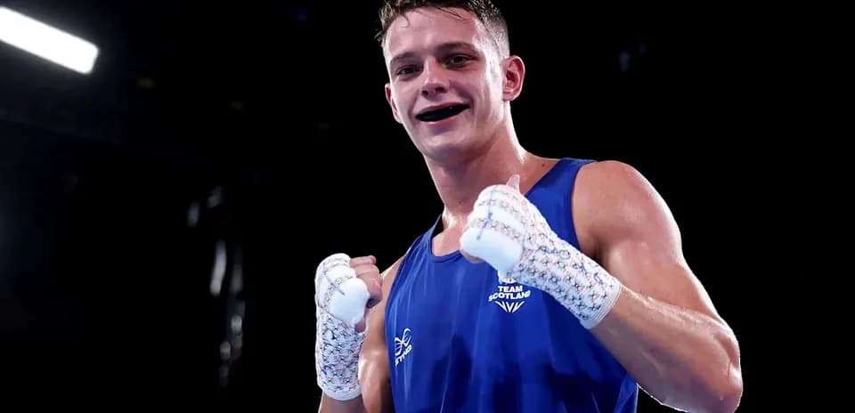 Boxer in blue gloves celebrating victory in ring