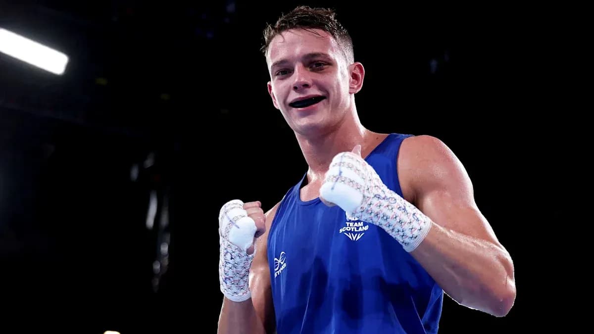 Boxer in blue gloves celebrating victory in ring