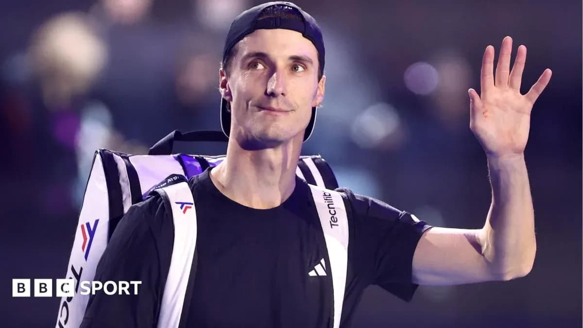 Tennis player waving while carrying backpack