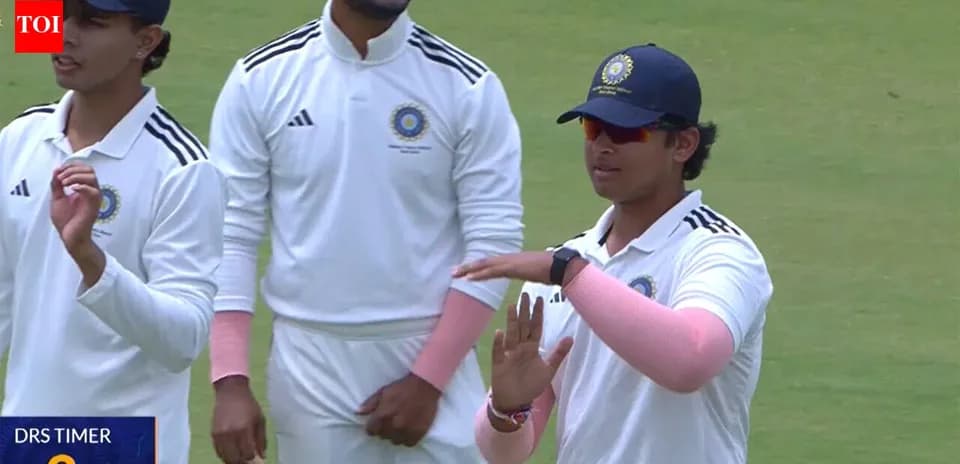 Cricketers discussing strategy on the field