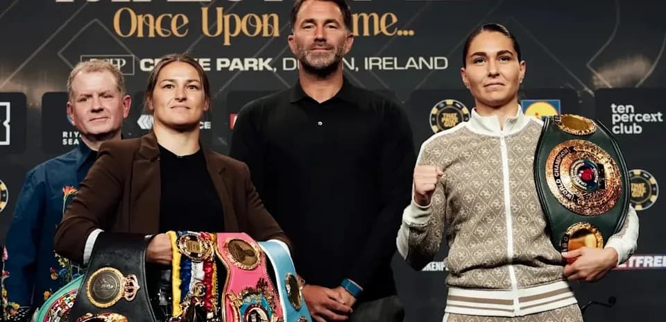 Two boxers with championship belts at press conference