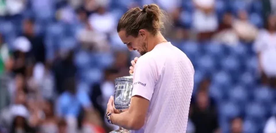 Player holding trophy after winning the match
