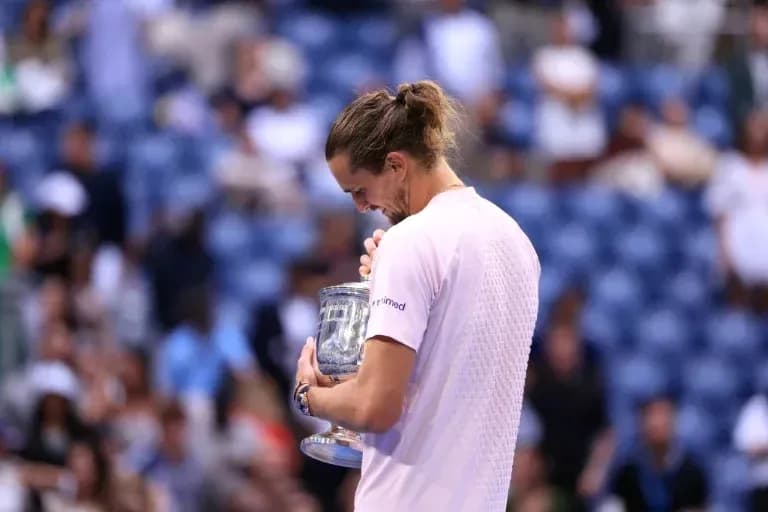 Player holding trophy after winning the match