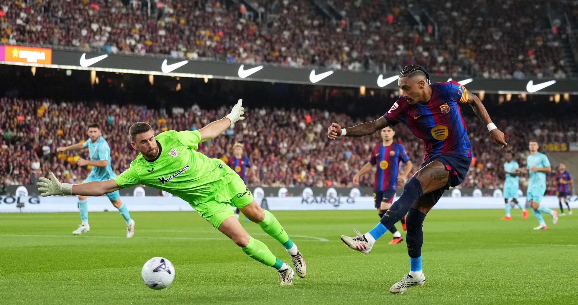 Goalkeeper diving as player attempts to score