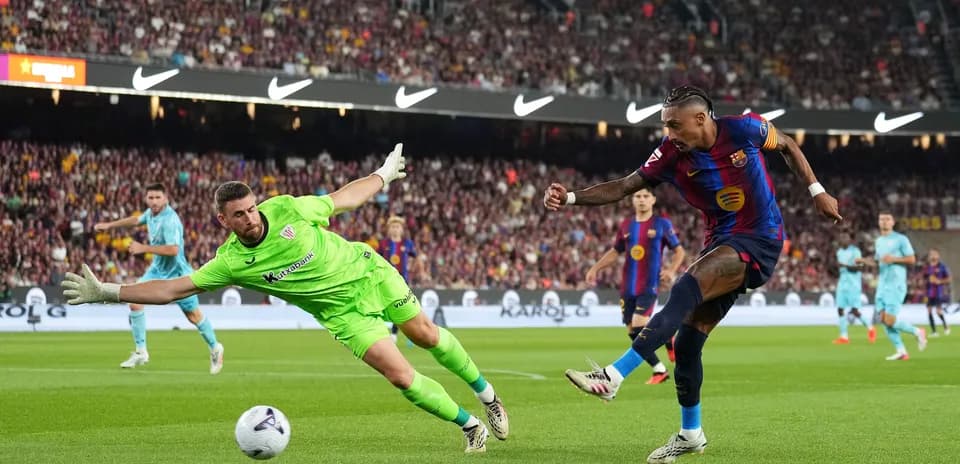 Goalkeeper diving as player attempts to score