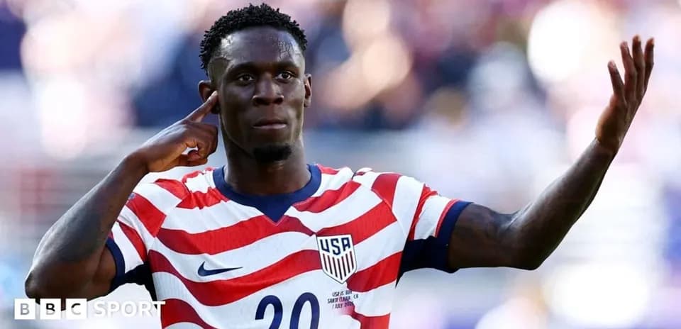 Player celebrating goal with hand gesture on field
