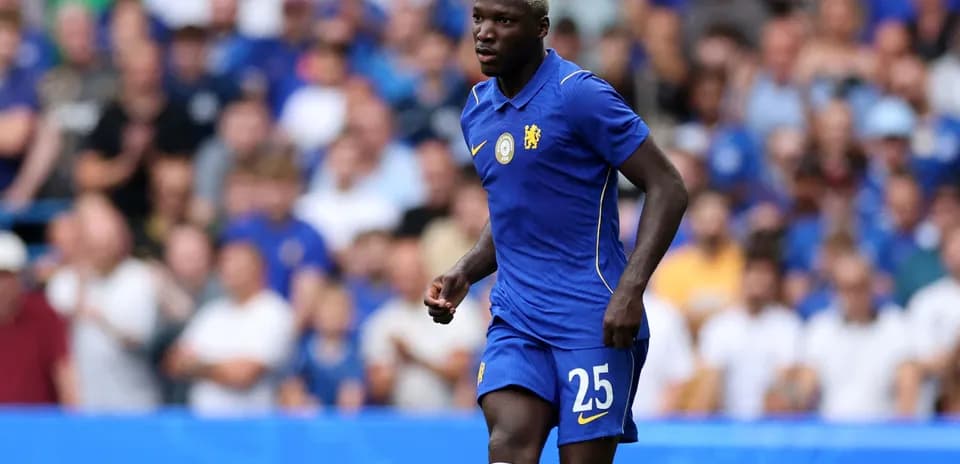 Player in blue jersey during match at stadium