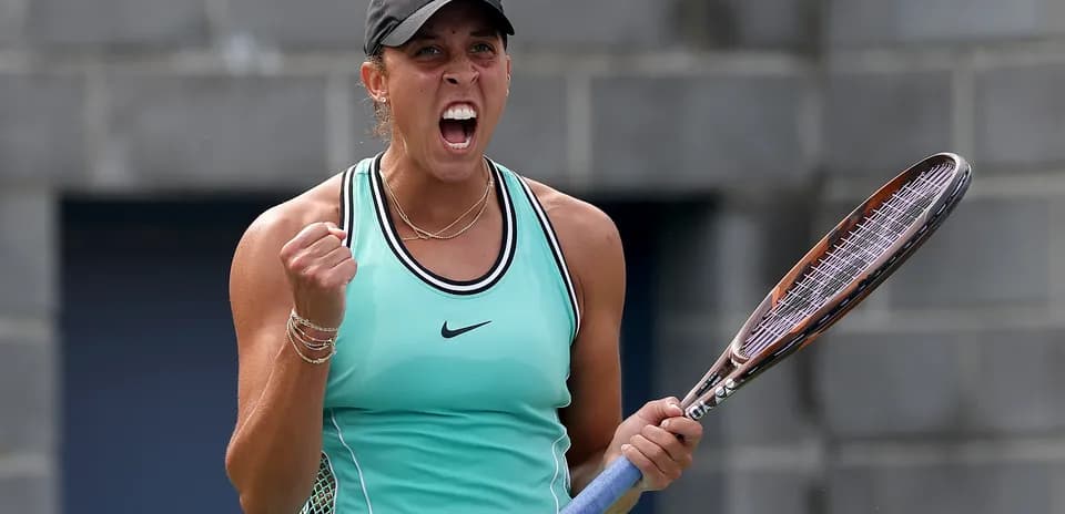 Tennis player celebrating with racket in hand