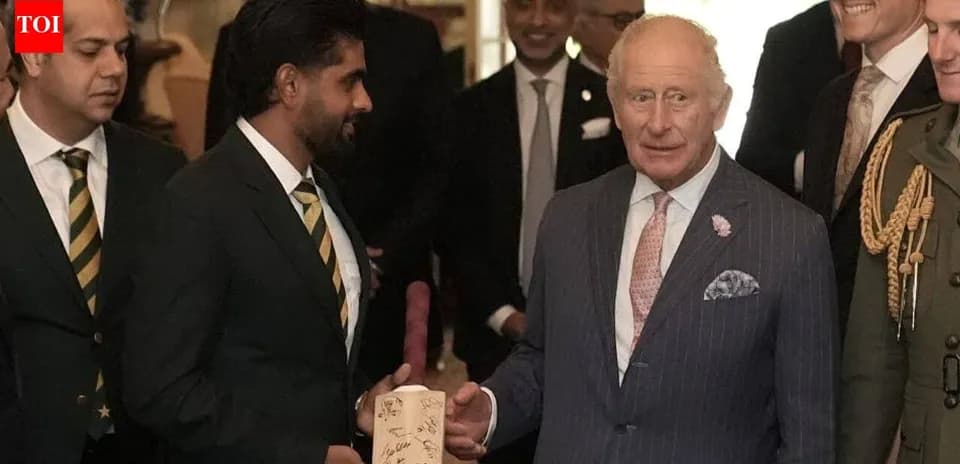 Cricketers presenting a signed bat to King Charles