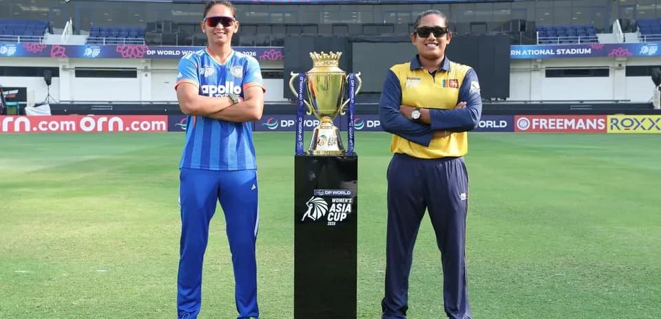 Two captains posing with Women's Asia Cup trophy