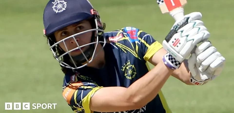Cricketer batting during match with focused expression