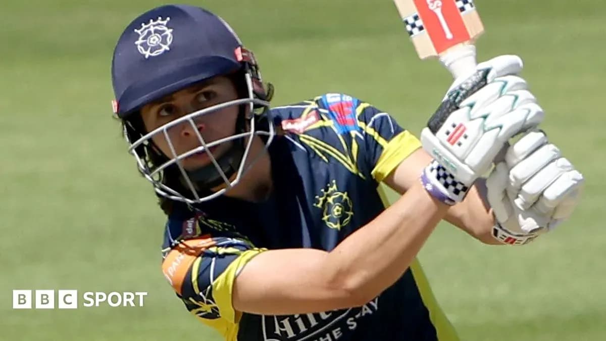 Cricketer batting during match with focused expression
