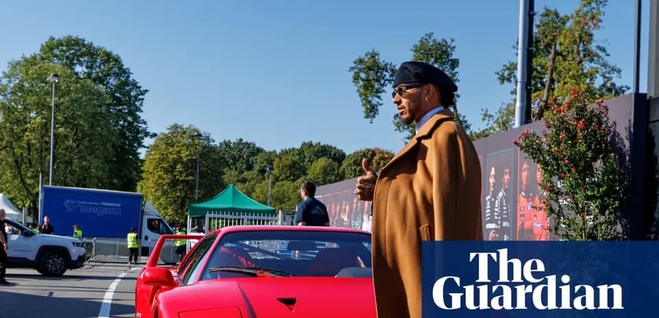Person beside red sports car at event