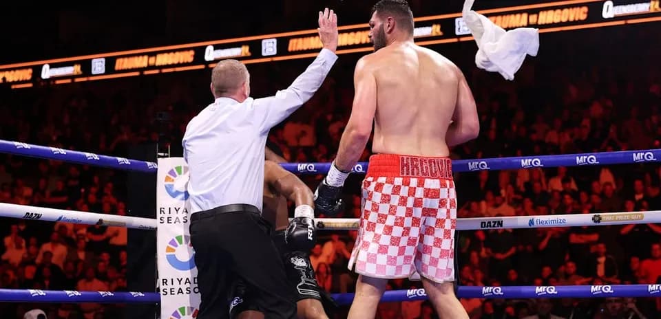 Referee stopping the boxing match in the ring