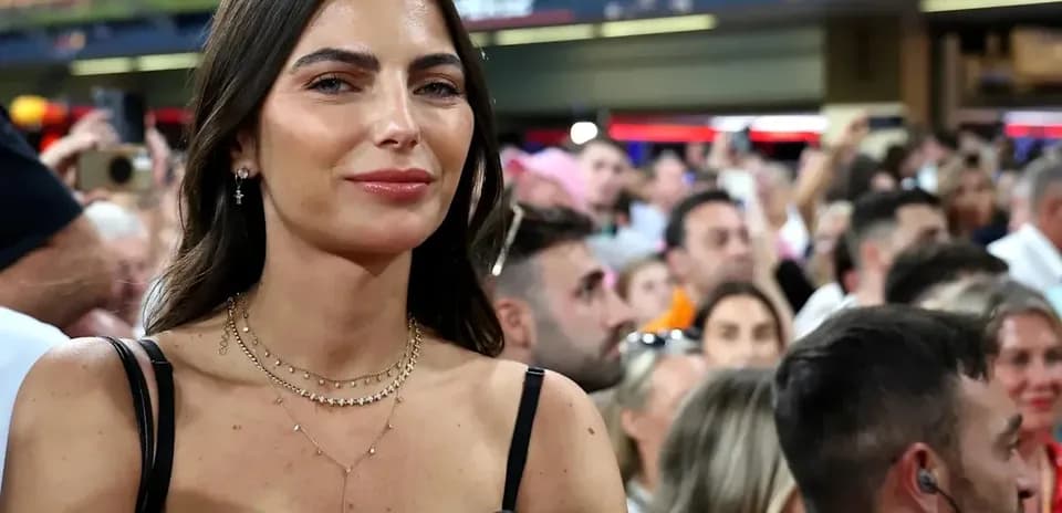 Woman smiling in crowded stadium during event