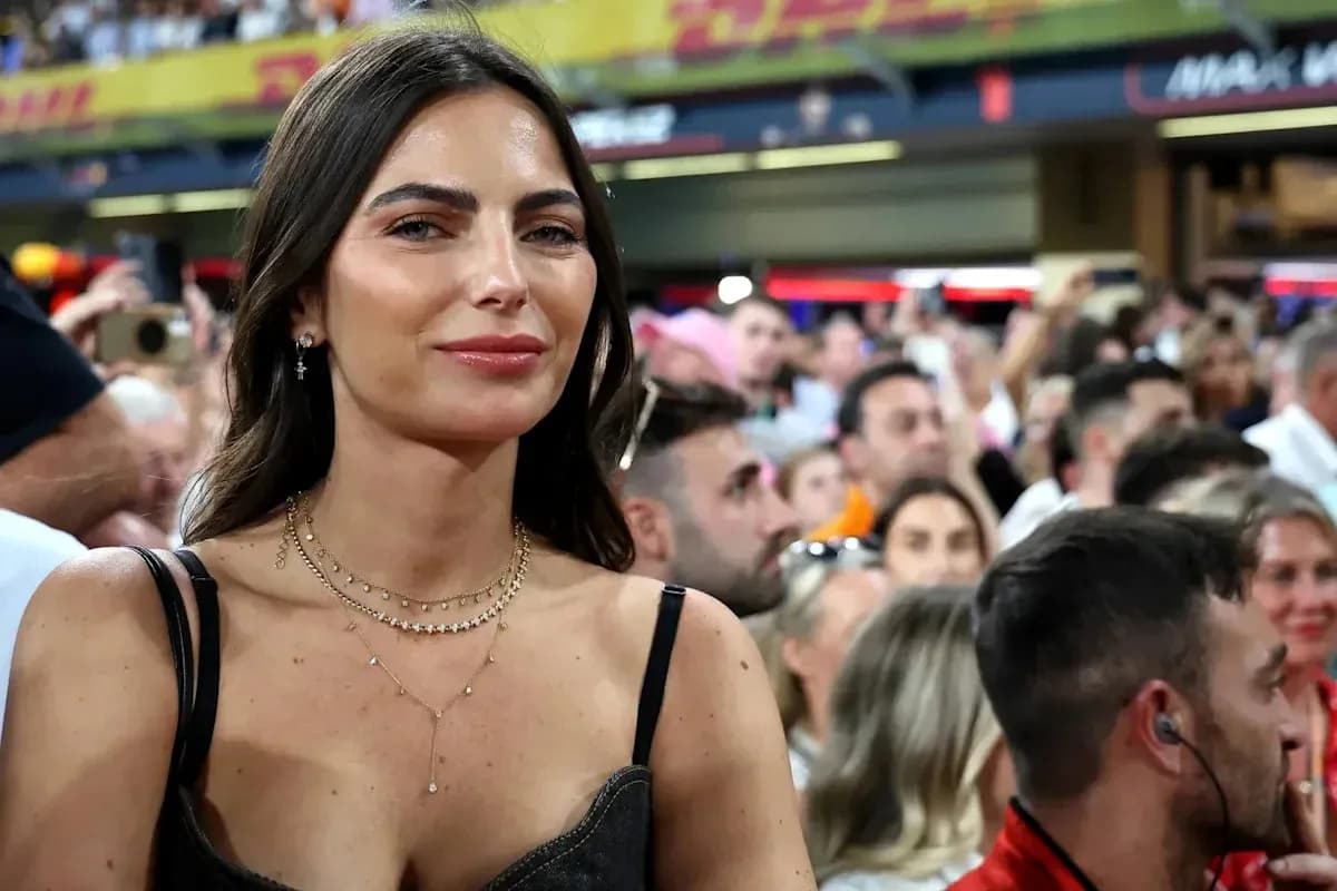 Woman smiling in crowded stadium during event