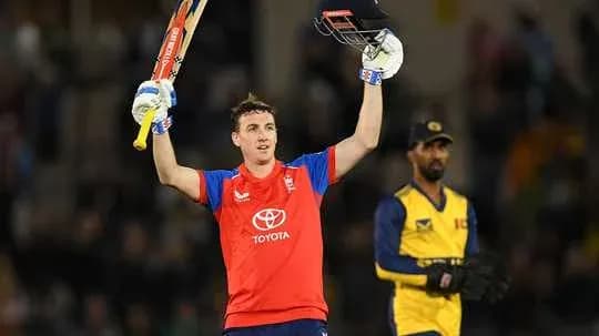 Batsman celebrating century with raised bat in match