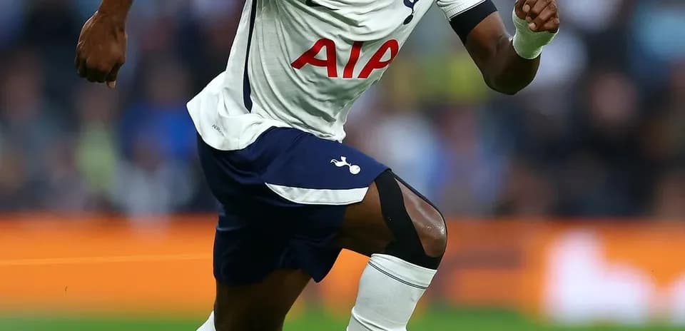 Tottenham player sprinting towards the ball on field