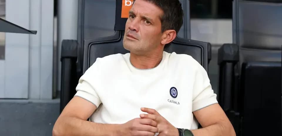 Coach sitting in the dugout during a match