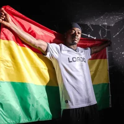 Player holding a flag with green, yellow, and red stripes