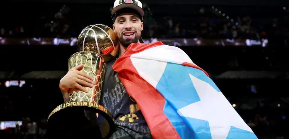 Player celebrating with trophy and flag after championship win
