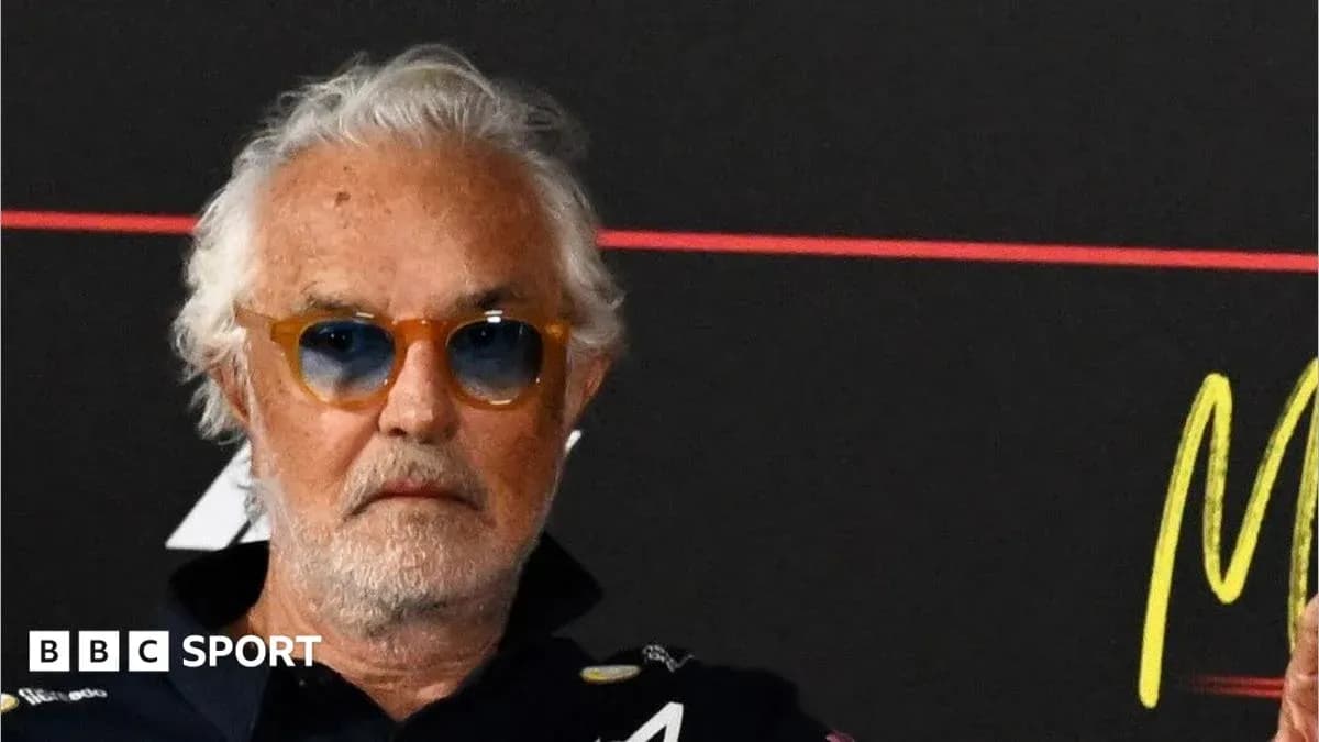 Man with sunglasses at press conference backdrop