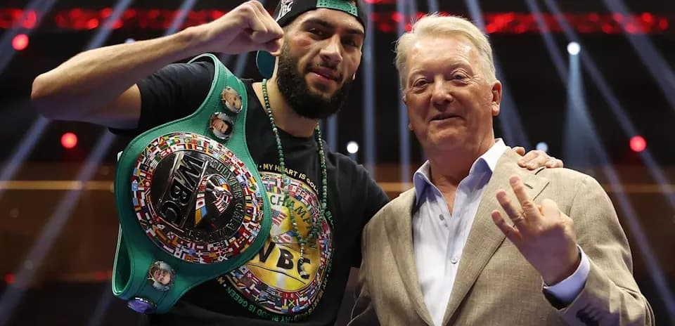 Boxer celebrating with championship belt and promoter