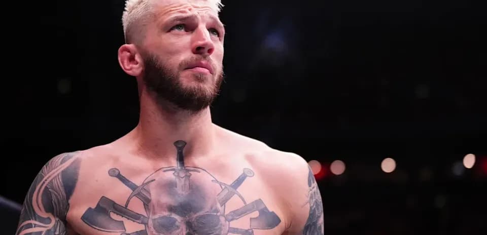 Bare-chested fighter with tattoos in the ring