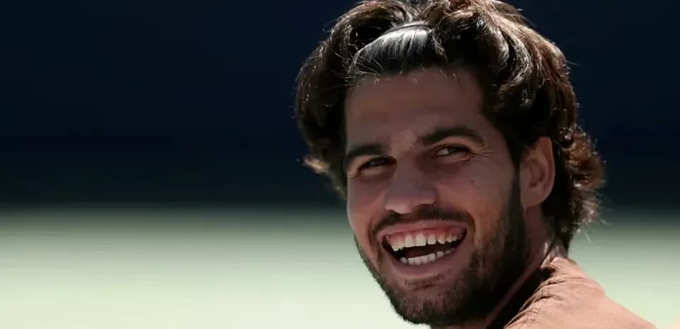 Tennis player smiling during a practice session